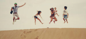 family jumping sand dune